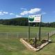 Park entrance sign and fenced field — shows property entry and landscape; comes from the campground gallery page.
