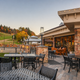Outdoor terrace and lodge dining area with ski slope visible in background — useful for showing guest facilities and relation to the mountain. Appears on the resort homepage.