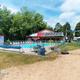 Outdoor pool and surrounding area with resort branding watermark — shows on-site swimming facility and layout useful for guests.