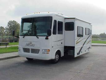 Front-quarter view of an Allegro motorhome with slide-out beside a water feature and paved lot; homepage image illustrating vehicle inventory and the lot surroundings (page: Motorhome Rentals and Service Center).