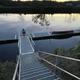 The 60-foot dock at Riverside Camping & RV Resort at dusk with stairs descending from the bank and a canoe ready for launch on the Connecticut River