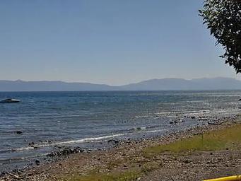 The rocky shoreline of a mountain lake