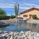 Clear, high-resolution view of the property’s decorative turtle pond and adjacent building — shows on-site landscaping, rock-lined pond, cactus and pool waterfall. Source page is the park’s official site (Turtle Pond images).