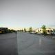 Perspective of park road and several parked RVs on concrete pads, illustrating site layout and roadway — corresponds to the rates/site layout photos on the property site (page: /rates).