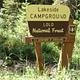 Lakeside Campground Entrance Sign- it is Cream and Brown in Color with a Forest Service Shield