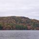 Wide lakescape with treed shoreline and fall foliage across the water — good scenic overview of the lake and surroundings from the property's Photos gallery.