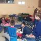 Indoor photo of a group activity/children’s sleepover area with cots and picnic-style tables — useful to represent on-site community/indoor facilities (present on the site’s activity/photos section). 