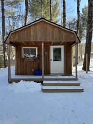 Small wooden cabin in snow—shows the campground’s cabin lodging option and seasonal conditions; sourced from the campground’s photo gallery.
