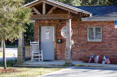 Close-up of the brick office/building entrance with rocking chair — shows on-site facilities and building character (image from the gallery highlighting the office/service building).