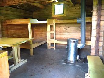Shakes Slough 1 Cabin interior showing wood beds  and table