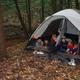Riverside tent campsite beside a stream with wooded surroundings — aligns with the River's Edge camping area page and illustrates creekside tent camping available on the property.