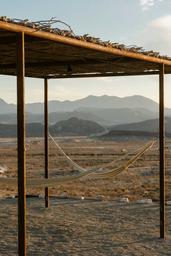 Hammocks overlooking the Christmas Mountains in Camp Elena's common area in Terlingua, Texas, near Big Bend National Park.
