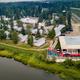 Aerial/drone-style view of the riverfront resort and cottages including the RV/campsite area and main facilities — provides an overall layout and context from above.