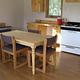 A small wooden kitchen table and counters in a cabin