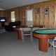 Interior shot of a clubhouse/game room with pool table and seating — documents on-site indoor facilities. Source: ‘Facilities | Watts RV Park’ page (facilities_right_pic1-1).