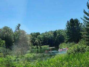 Group kayaking and inner tube floating on the Platte River