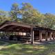 Large covered pavilion with picnic tables and string lights — highlights a communal facility for events and gatherings shown on the property pages.