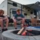 Evening campsite scene with RV, seating and a fire ring where guests roast marshmallows—depicts typical RV/campsite experience at the KOA (from the campground's ways-to-stay photos).