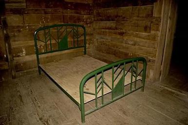 Full size metal bed frame inside cabin
