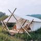 Glamping-style tent on a raised platform set in natural vegetation — shows on-site lodging/guest accommodation option promoted on the property.