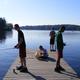 Dock scene with campers fishing on a wooden pier and Long Lake in background — clearly shows waterfront recreation on the campground (source: Boating page).