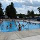 Main pool photograph showing the pool, deck and RVs/campsites in the background — clearly a core amenity of the campground from the official site.