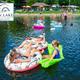 Crowd enjoying the water on tubes and floats near the swim area and lakeshore — demonstrates active waterfront amenities (gallery image on site).