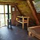 Shakes Slough 2 Cabin interior showing wood bunk, table stove and vertical ladder to loft