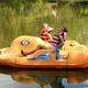 Paddleboat with children on a calm lake — demonstrates another on-site water activity (paddleboats) visible in site imagery.