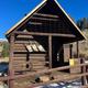 Brown Cabin with snow on the ground