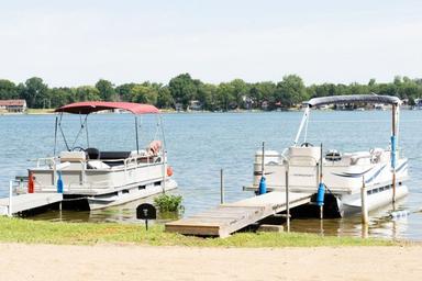 Boats docked on the lake with shoreline visible — clear view of waterfront and marina-type access at Atwood Lake (on the features/media pages).
