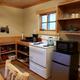 View of kitchen amenities including electric oven/range, refrigerator, microwave
