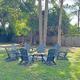 Outdoor firepit seating area on grass — highlights an additional common amenity and outdoor gathering space on the property.