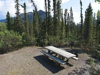 Marion Creek Campground campsite with picnic table and fire ring.