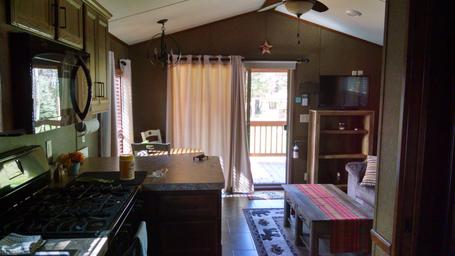 Interior view of the porch-cabin living area showing layout, kitchen and entry to deck — useful to illustrate cabin interiors for guests (rental unit page).