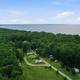 Aerial/drone view showing the campground layout with RVs, roads and dense tree line on the lakeshore — supports property-wide overview (sourced from site gallery background image of park grounds).