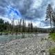 river with rock shore under cloudy sky