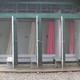 Outdoor shower/toilet stalls (campground bathhouse showers) — shows on-site sanitary facilities, from the Amenities page.