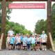 Frontal group photo under a large 'Herkimer Diamond Mines' entry sign — clearly shows the property entrance and gathering area, useful for visitors.
