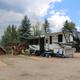 Photo of an RV parked at a paved RV pad with outdoor seating and campground landscaping — useful depiction of RV/5th-wheel sites at the property (matches ‘ways to stay’ content).
