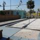 Photo of bocce/playing courts and nearby buildings — highlights on-site recreation facilities and layout of common areas.