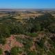 High-resolution aerial/drone view over the campground area showing forested ridges and distant plains — useful as an overview; sourced from the site's home page background image.