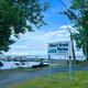 Photo of the Gilbert Brook Marina sign with docks and boats visible — directly from the Marina page, shows on-property marina facilities.