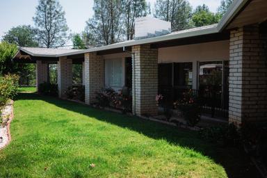 Photo of on-site residential building with landscaping and lawn area — demonstrates accommodation/grounds on the Twin View Terrace property (gallery image).