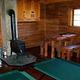 A stove and other furniture inside a wooden cabin