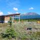Pavilion structure with picnic tables, cornhole and expansive mountain views — highlights communal facilities and site setting (from The Pavilion page).