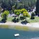 Aerial/shoreline photo of the lake beach, docks and marina area — strong property overview of Pine Mountain Lake from the main site (useful scenic view and public beach/marina facility).