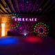 Interior photo of the event space labeled 'The Birdcage' with lighting and signage — documents an on-site activity/meeting venue seen on the property website.