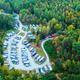 High-altitude aerial view showing the campground layout with clustered RV sites, access roads, and surrounding forest — good overall overview; image is from the Green Mountain Park resort page.