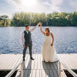 Couple on a dock overlooking the river — from the weddings/events gallery but also shows the resort dock and riverfront decking, a useful scenic shot of the property’s shoreline amenities.